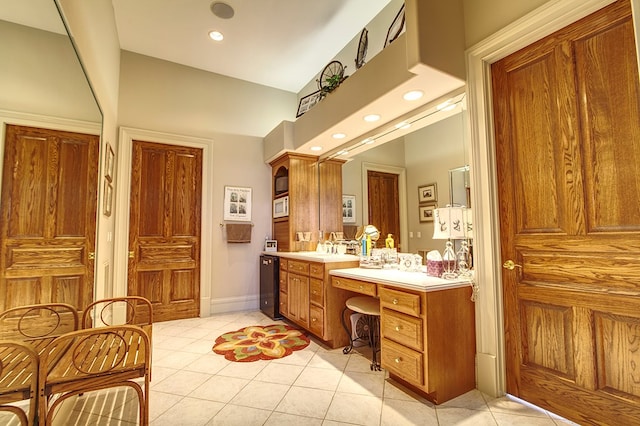 bathroom with baseboards, tile patterned flooring, vanity, and recessed lighting