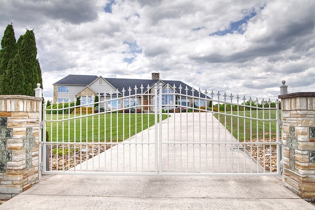 view of gate with a yard