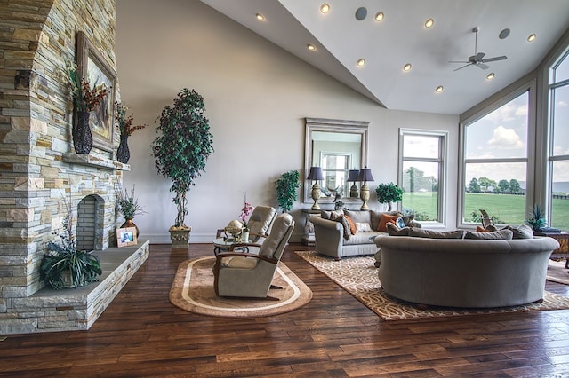 living room featuring dark wood-style floors, high vaulted ceiling, a fireplace, and a ceiling fan