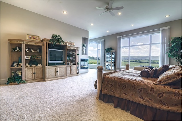 bedroom with light carpet, access to outside, a ceiling fan, and recessed lighting