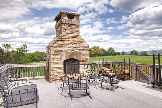 view of patio featuring an outdoor stone fireplace