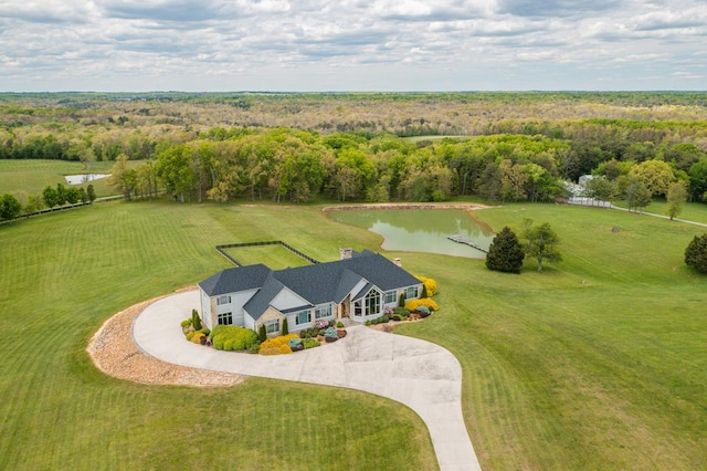 drone / aerial view featuring a water view and a forest view