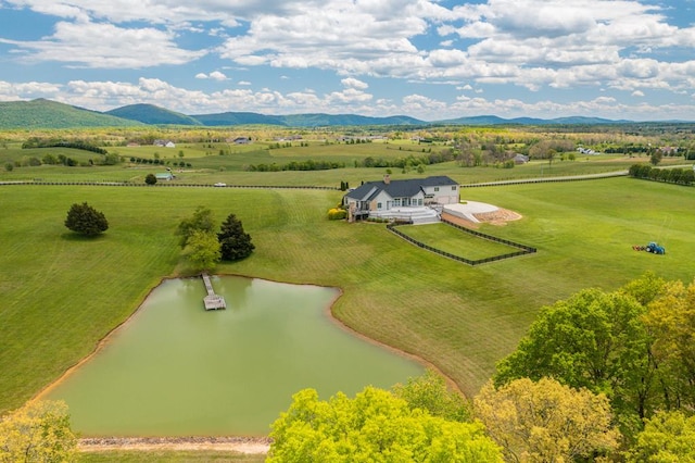 drone / aerial view featuring a rural view and a water and mountain view