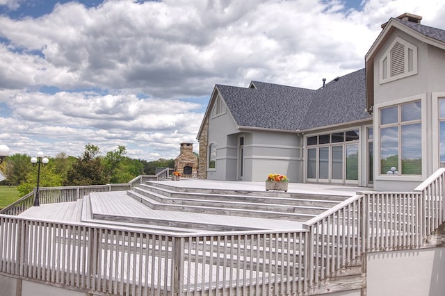 view of pool with an outdoor stone fireplace