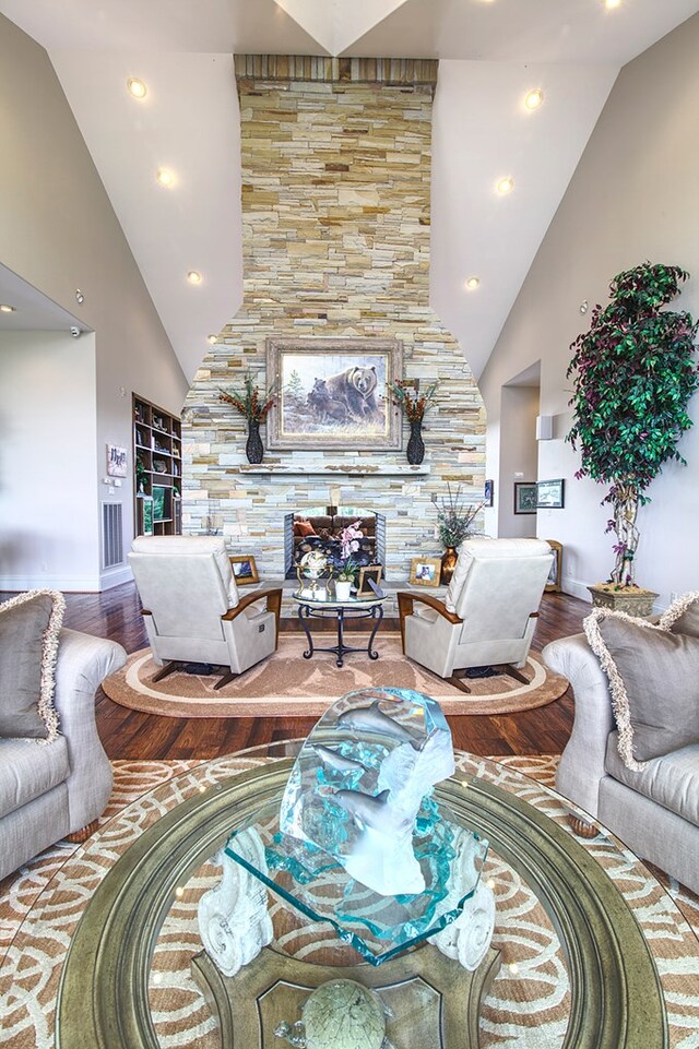 living area featuring high vaulted ceiling, wood finished floors, and recessed lighting