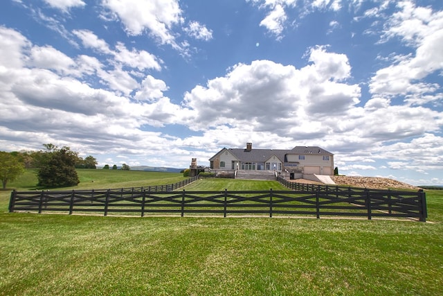 view of yard featuring a fenced front yard and a rural view