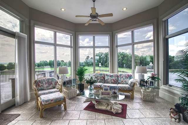 sunroom featuring a healthy amount of sunlight and ceiling fan