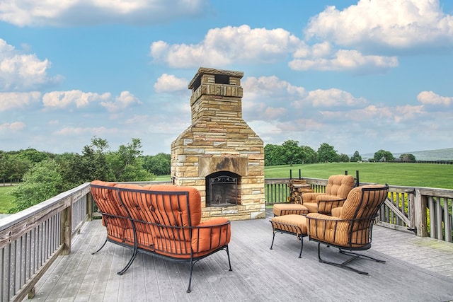 deck with an outdoor stone fireplace