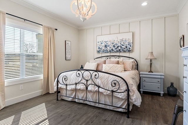 bedroom with baseboards, dark wood-type flooring, a chandelier, and crown molding