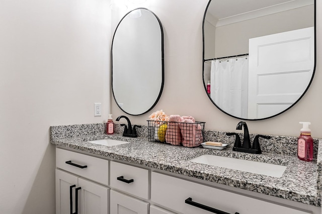 bathroom featuring a sink, double vanity, and crown molding