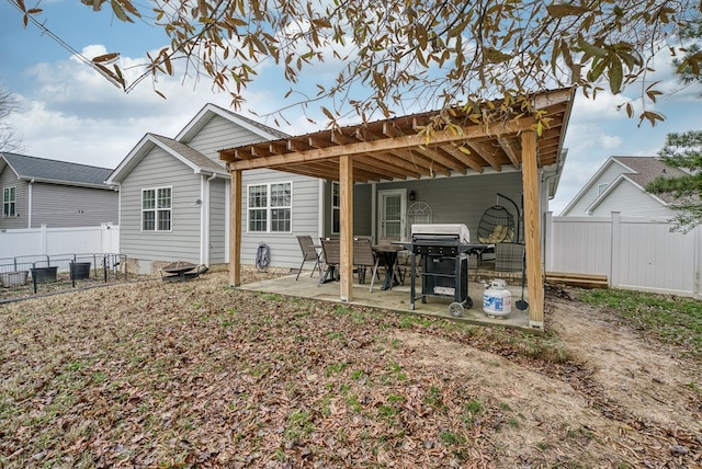 rear view of property featuring a patio and fence