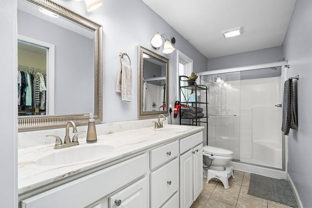 full bathroom featuring a stall shower, a sink, and toilet