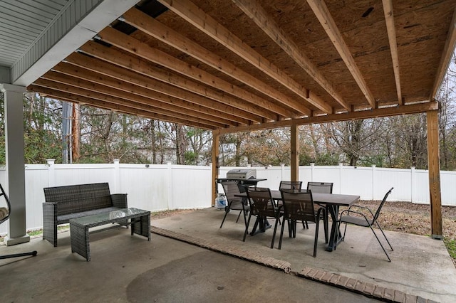 view of patio / terrace with outdoor dining space, a fenced backyard, and a grill