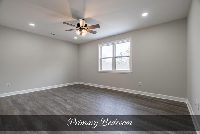 empty room featuring dark wood-style floors, baseboards, visible vents, and recessed lighting