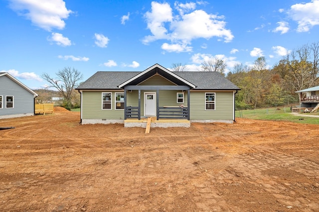 view of front of property featuring crawl space, a shingled roof, and a porch