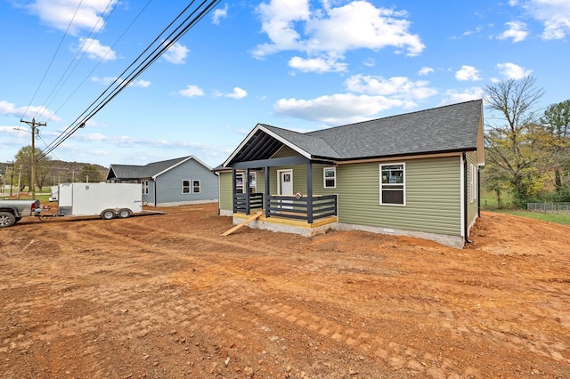 view of front of house with crawl space and a shingled roof