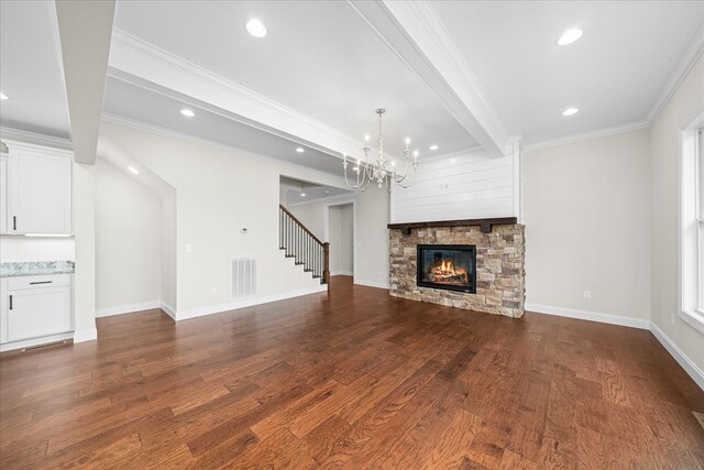 unfurnished living room with visible vents, baseboards, stairs, dark wood-style floors, and crown molding