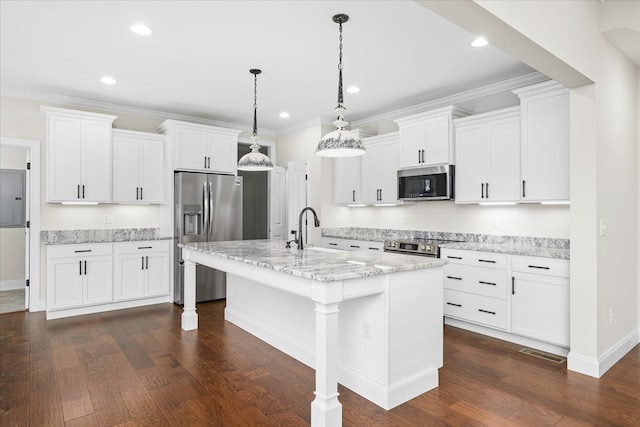 kitchen featuring an island with sink, appliances with stainless steel finishes, hanging light fixtures, white cabinetry, and a sink