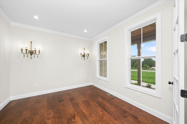 unfurnished room featuring dark wood finished floors, recessed lighting, visible vents, ornamental molding, and baseboards