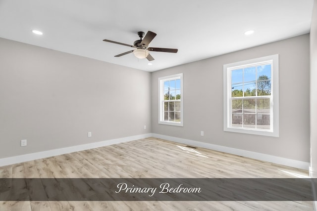 empty room featuring light wood finished floors, recessed lighting, visible vents, ceiling fan, and baseboards