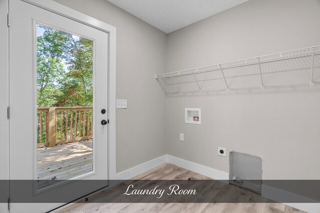 clothes washing area with laundry area, baseboards, wood finished floors, hookup for a washing machine, and electric dryer hookup