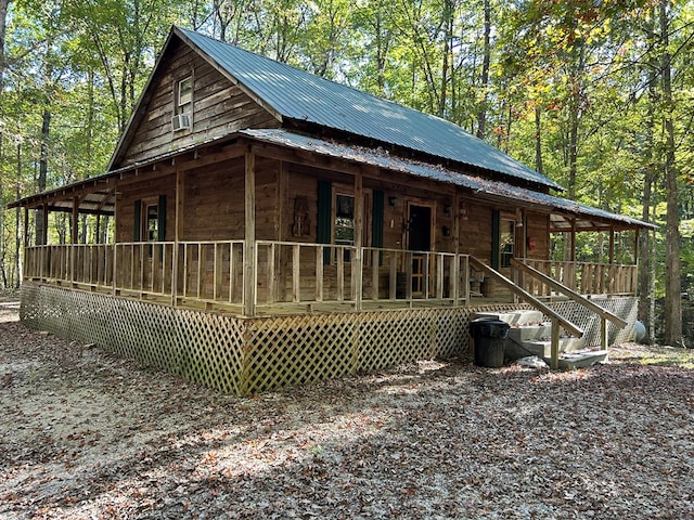 view of front of home with a porch and metal roof