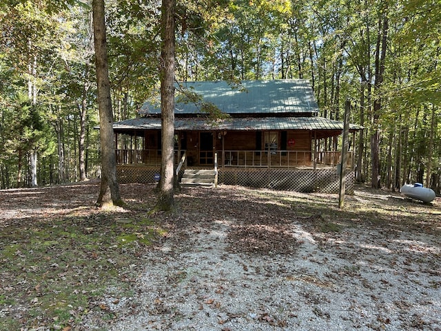 chalet / cabin with metal roof and a porch