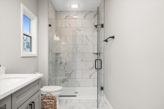 full bath featuring baseboards, toilet, a stall shower, and vanity