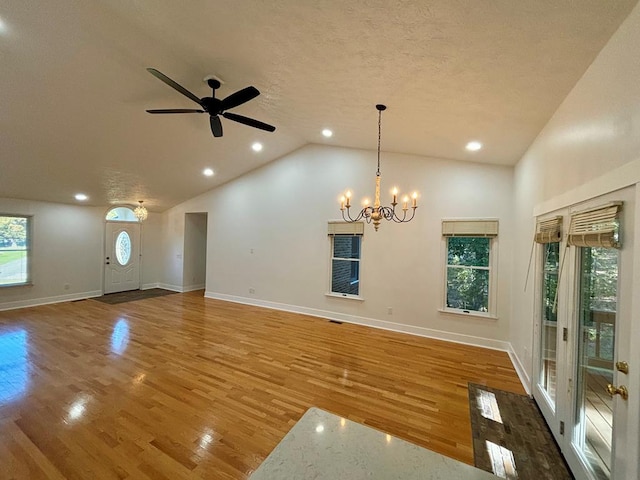 unfurnished living room featuring recessed lighting, a textured ceiling, wood finished floors, baseboards, and ceiling fan with notable chandelier