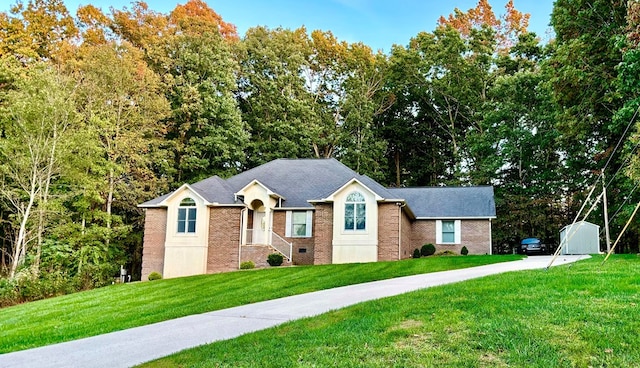 view of front of home with a front lawn, crawl space, and brick siding