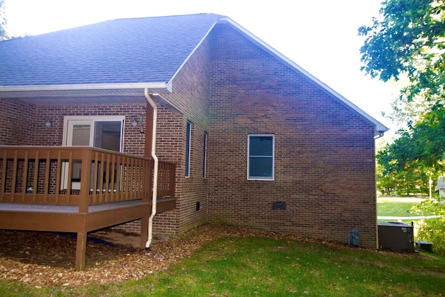 view of property exterior with crawl space, a wooden deck, and brick siding