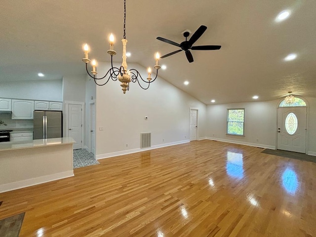 unfurnished living room with light wood-type flooring, baseboards, and visible vents