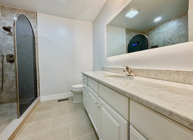 full bath with visible vents, toilet, vanity, a walk in shower, and baseboards