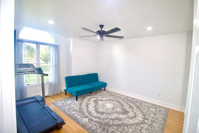 exercise room featuring a ceiling fan, baseboards, wood finished floors, and recessed lighting