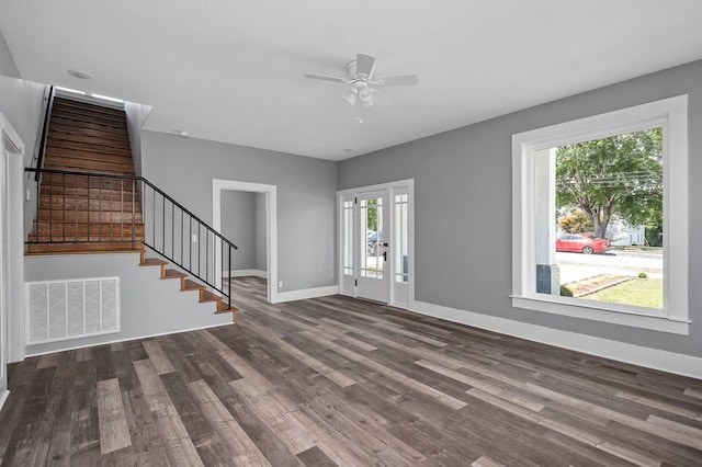 foyer with baseboards, visible vents, ceiling fan, stairway, and dark wood-type flooring