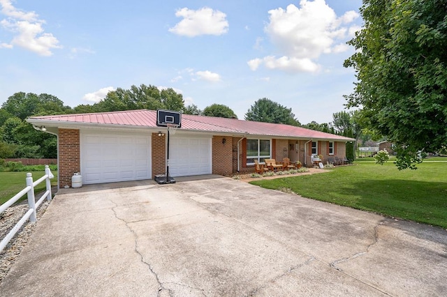 ranch-style home featuring driveway, brick siding, metal roof, fence, and a front yard