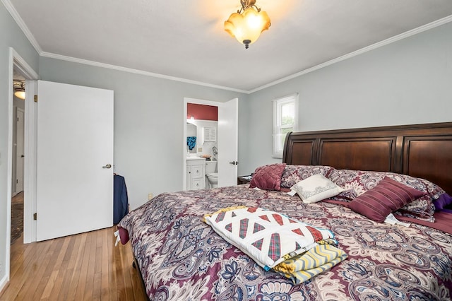 bedroom with light wood-type flooring, ornamental molding, and connected bathroom