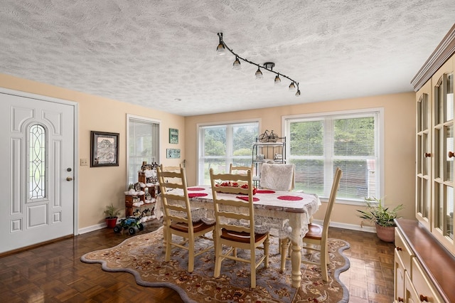 dining area with a textured ceiling and baseboards