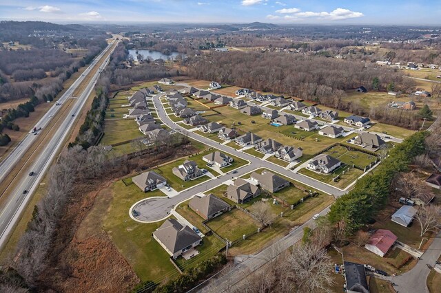 bird's eye view featuring a water view and a residential view