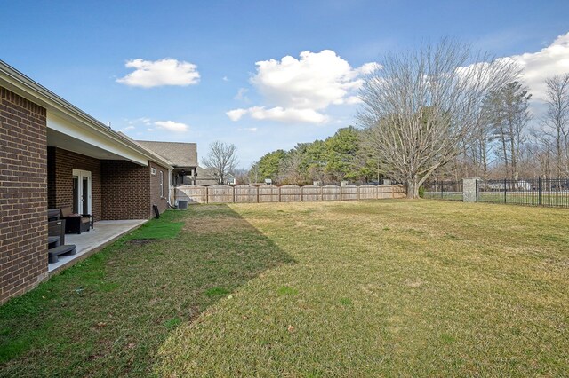 view of yard featuring a patio and a fenced backyard