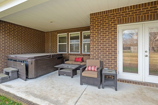 view of patio / terrace with french doors and a hot tub