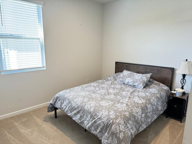 carpeted bedroom with baseboards