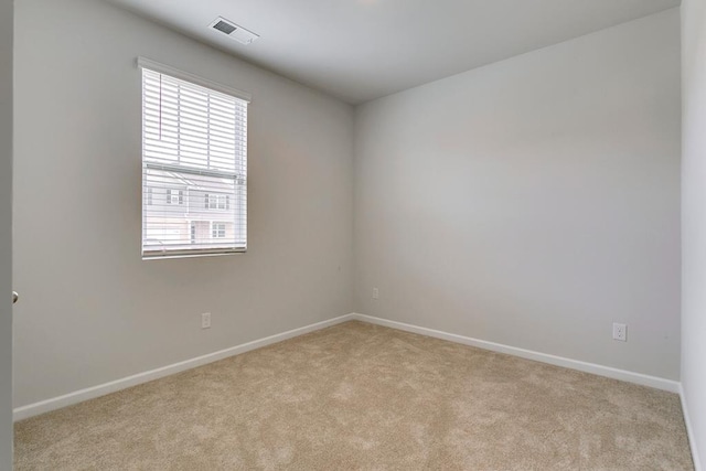 unfurnished room featuring light carpet, baseboards, and visible vents