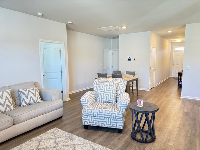 living room with baseboards and wood finished floors