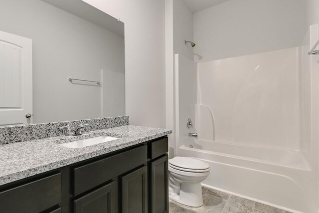 bathroom featuring toilet, vanity, and shower / bathtub combination