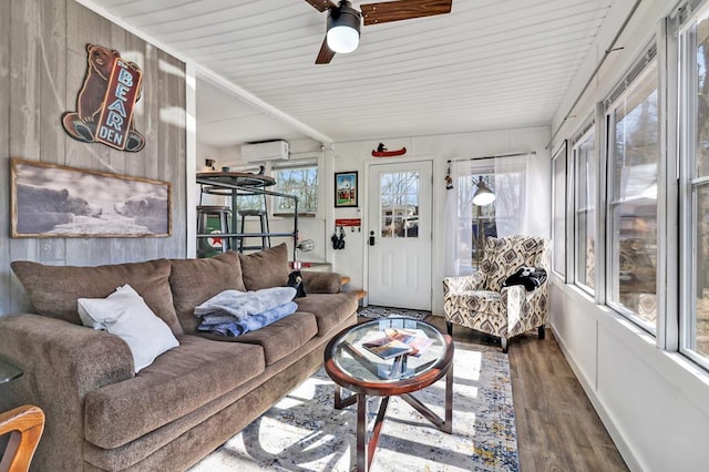 sunroom / solarium with an AC wall unit and a ceiling fan