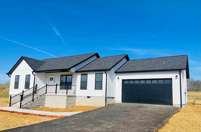 modern farmhouse style home with aphalt driveway, a porch, an attached garage, roof with shingles, and crawl space