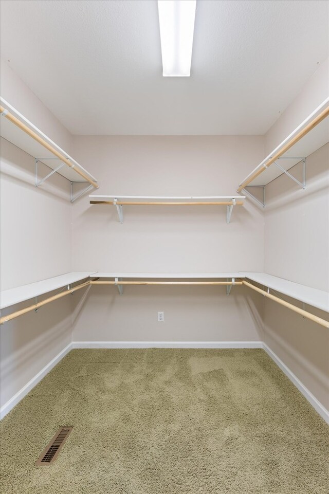 spacious closet with visible vents and carpet flooring