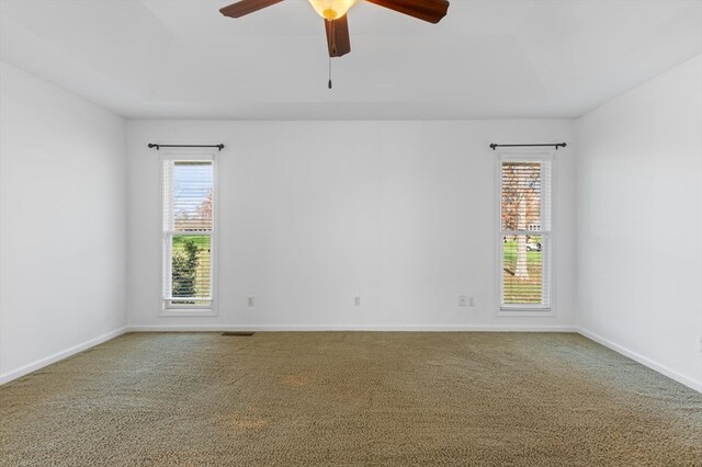 empty room featuring ceiling fan, baseboards, and carpet flooring