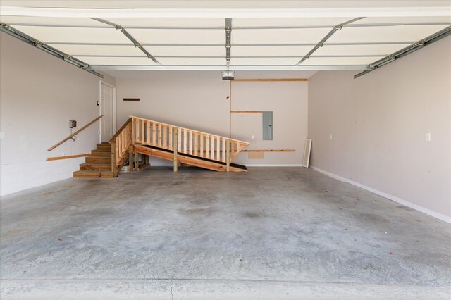 garage featuring a garage door opener and electric panel